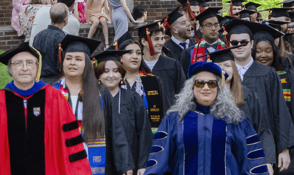 Professors walking in colorful robes